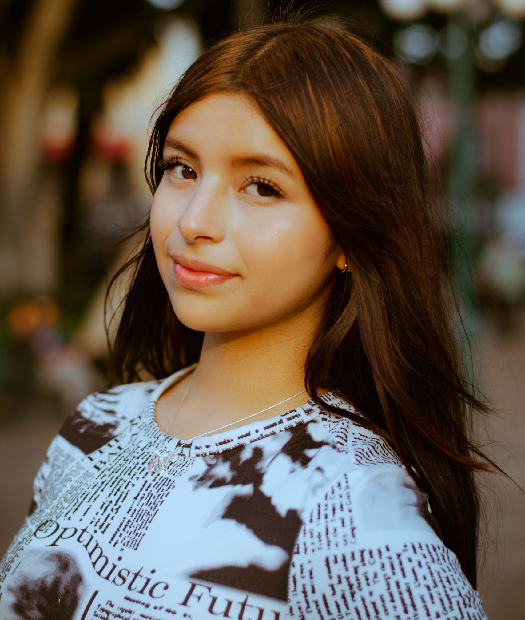 Portrait of a young woman smiling outdoors with soft lighting in Puebla, Mexico.